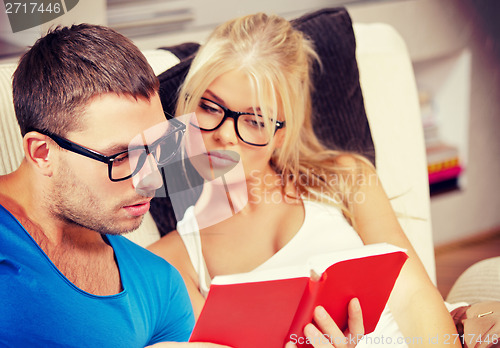 Image of couple at home with book