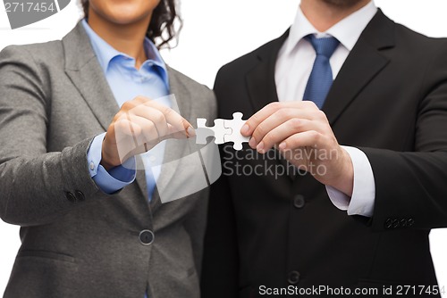 Image of businessman and businesswoman with puzzle pieces