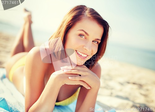 Image of girl sunbathing on the beach