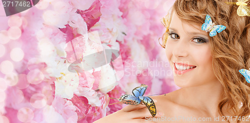 Image of happy teenage girl with butterflies in hair