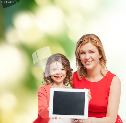 Image of smiling mother and daughter with tablet pc