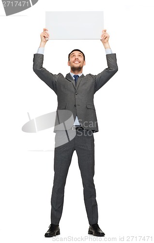 Image of smiling businessman with white blank board