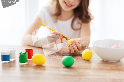 Image of close up of girl coloring eggs for easter