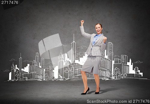 Image of happy businesswoman with hands up