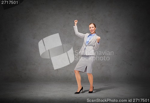 Image of happy businesswoman with hands up