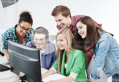 Image of students with computer studying at school