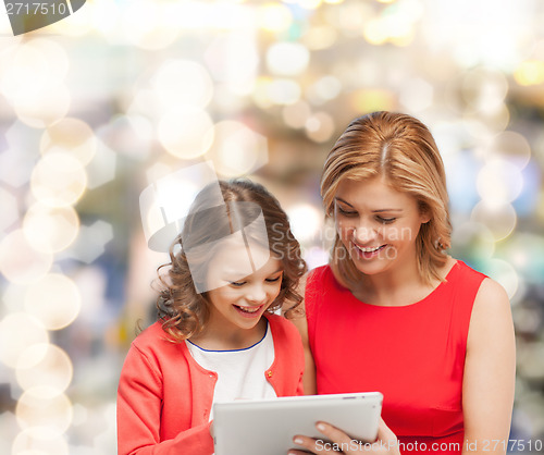 Image of mother and daughter with tablet pc computer