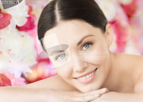 Image of smiling woman in spa lying on the massage desk