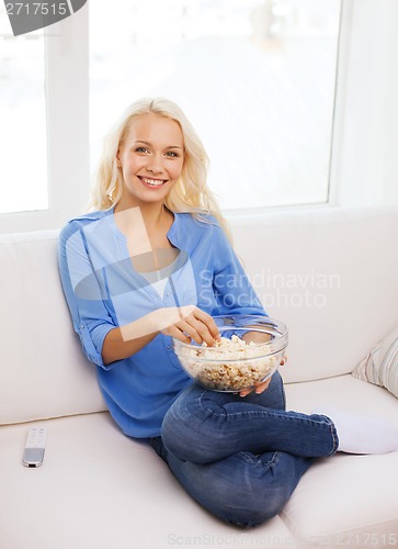 Image of young girl with popcorn ready to watch movie