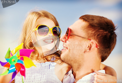 Image of happy father and child in sunglasses over blue sky