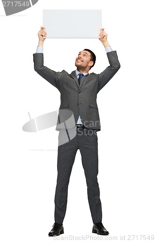 Image of smiling businessman with white blank board