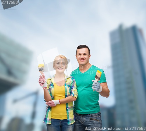Image of smiling couple with paintbrush