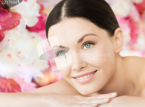 Image of smiling woman in spa lying on the massage desk