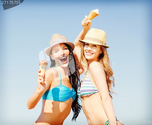 Image of girls in bikini with ice cream on the beach