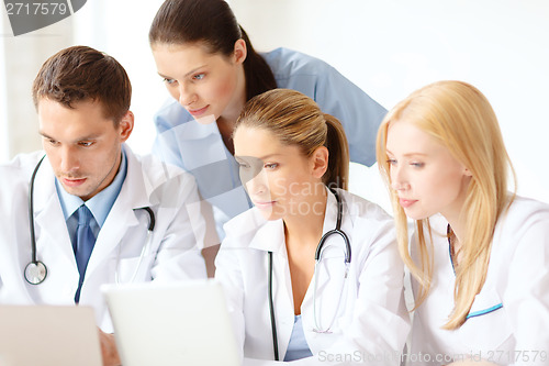 Image of group of doctors with laptop and tablet pc