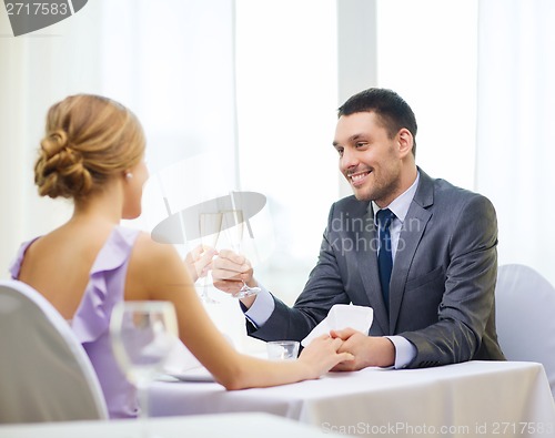 Image of couple with glasses of champagne at restaurant