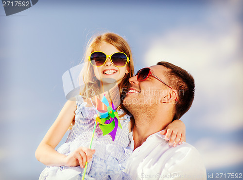 Image of happy father and child in sunglasses over blue sky