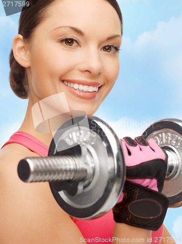 Image of asian sporty woman with heavy dumbbell