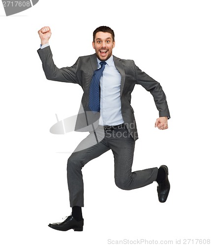 Image of smiling businessman jumping