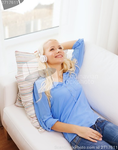 Image of smiling young girl in headphones at home