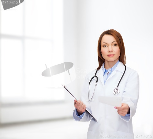 Image of calm female doctor with clipboard