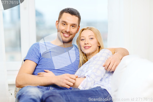 Image of smiling happy couple at home