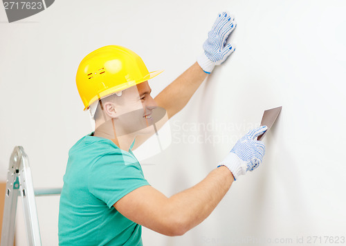 Image of smiling man in helmet doing renovations at home