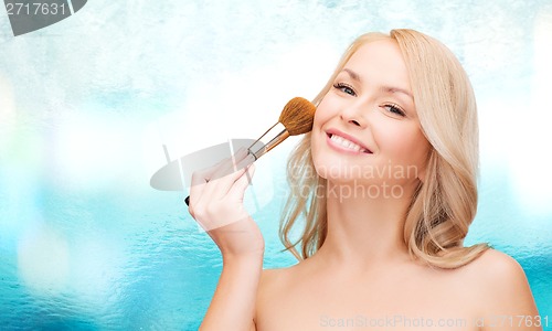 Image of beautiful woman with closed eyes and makeup brush