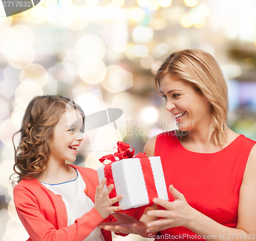 Image of smiling mother and daughter with gift box