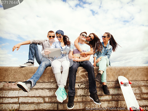 Image of group of teenagers looking at tablet pc