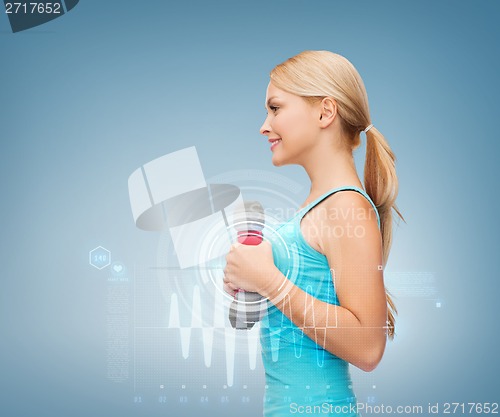 Image of young sporty woman with light dumbbells