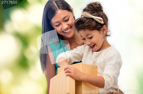 Image of happy mother and child girl with gift box