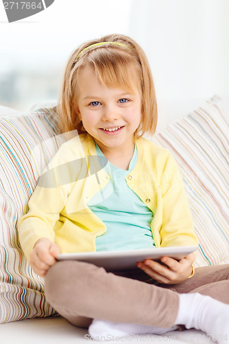 Image of smiling girl with tablet pc computer at home