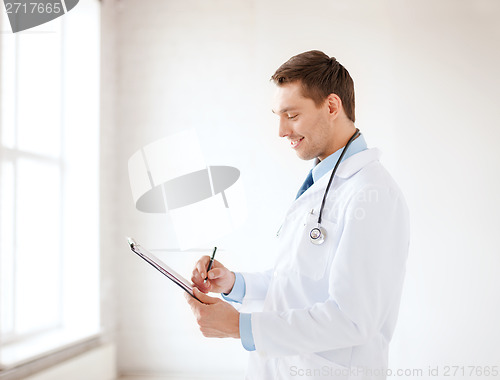 Image of smiling male doctor with stethoscope and clipboard