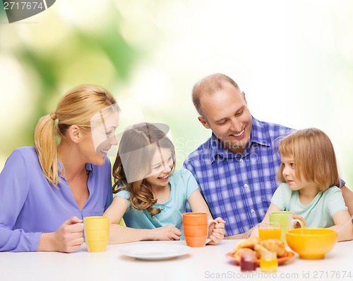 Image of happy family with two kids with having breakfast