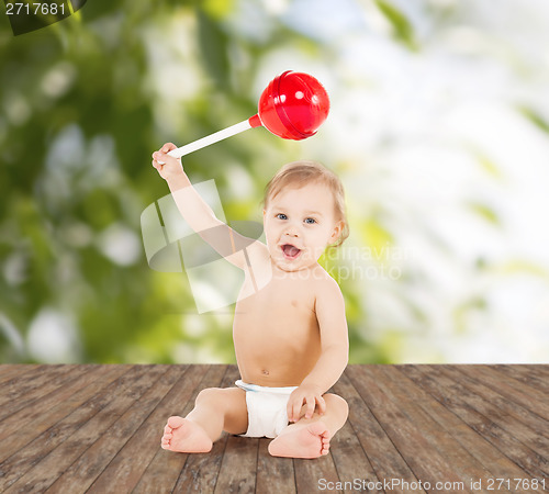 Image of cute little boy playing with big lollipop