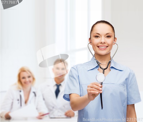 Image of smiling female doctor or nurse with stethoscope