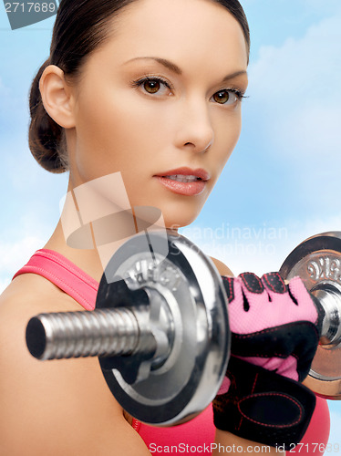 Image of asian sporty woman with heavy dumbbell