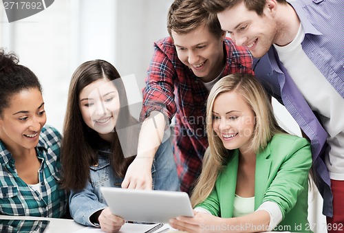 Image of students looking at tablet pc in lecture at school