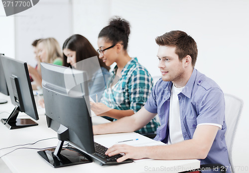 Image of student with computer studying at school