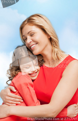 Image of smiling mother and daughter hugging