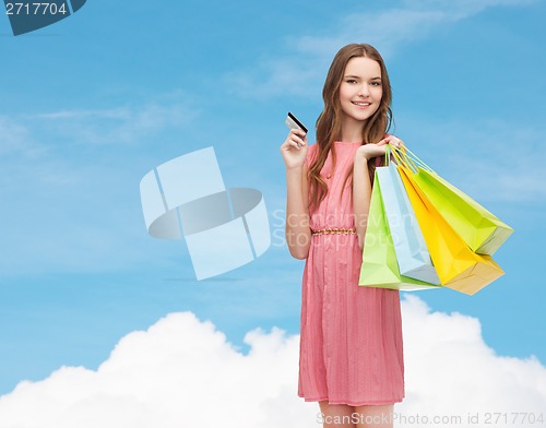 Image of smiling woman in dress with many shopping bags