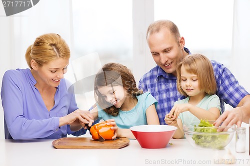 Image of happy family with two kids making dinner at home