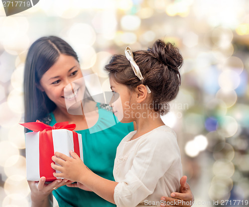 Image of happy mother and child girl with gift box