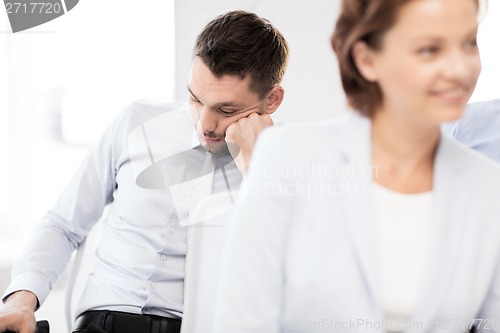 Image of tired businessmen sleeping on conference