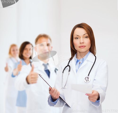 Image of calm female doctor with clipboard