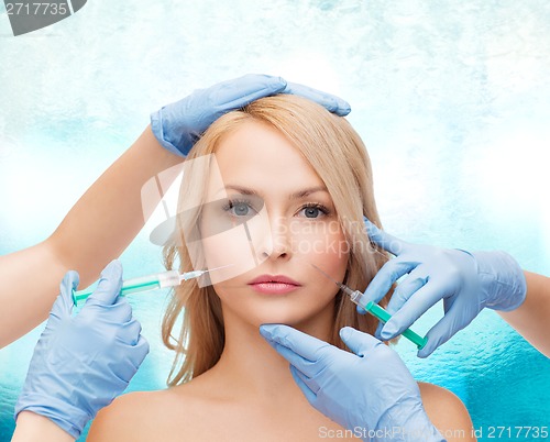 Image of woman face and beautician hands with syringes