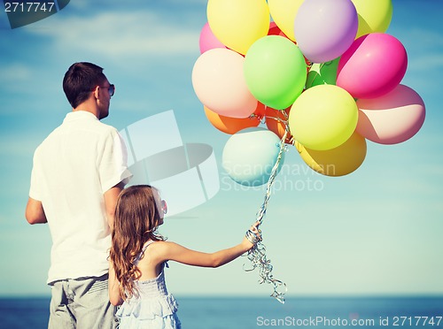 Image of father and daughter with colorful balloons