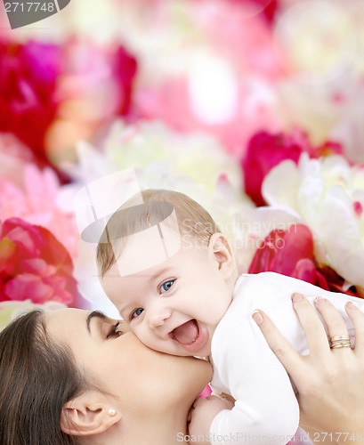 Image of laughing baby playing with mother