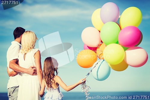 Image of family with colorful balloons